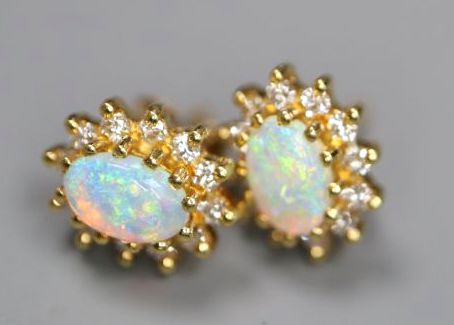 A pair of yellow metal and two stone oval white opal drop earrings, 32mm, gross 2.5 grams, and a pair of 750 and opal ear studs